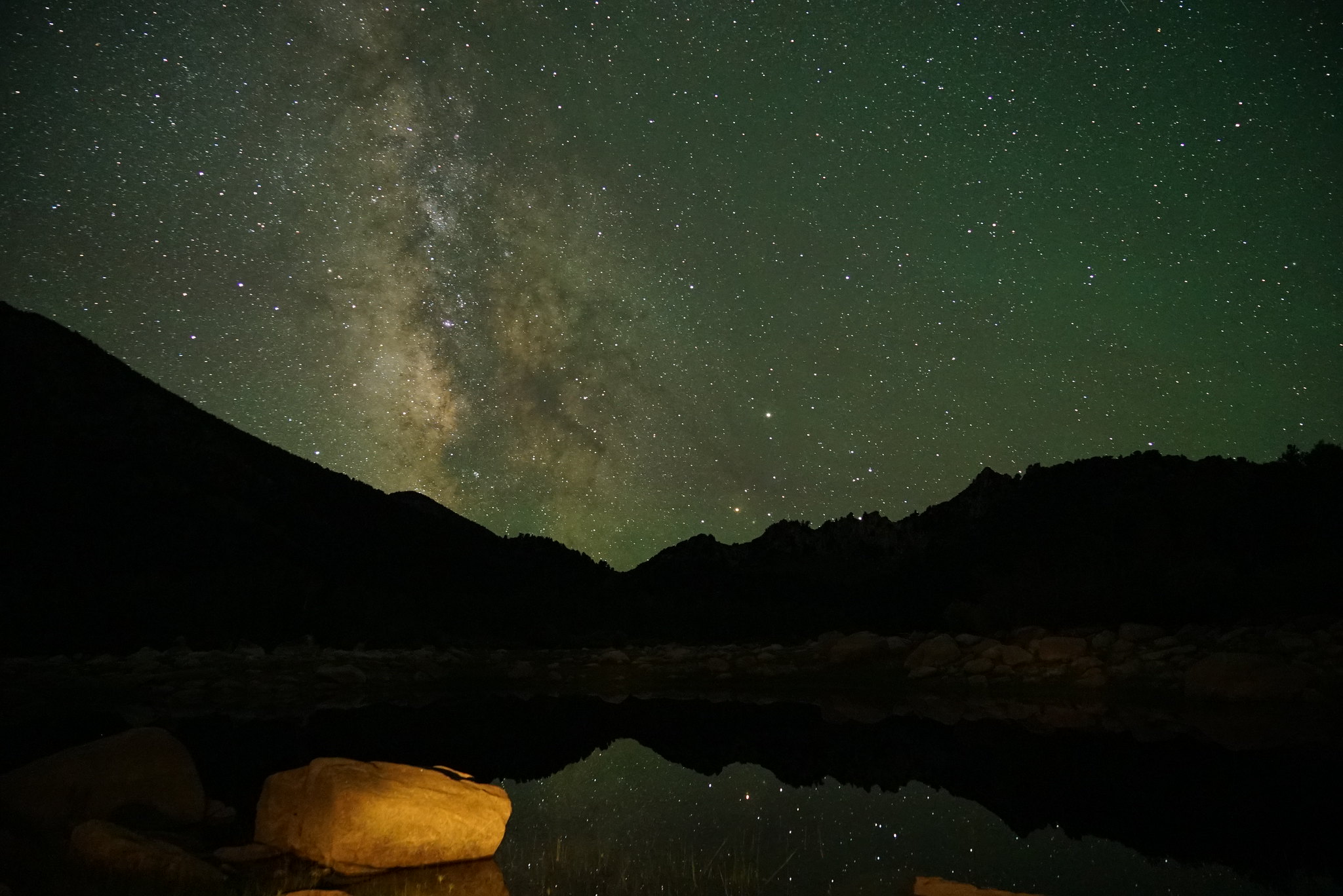 The Milky Way and thousands of stars reflected in still water on a dark Owyhee night